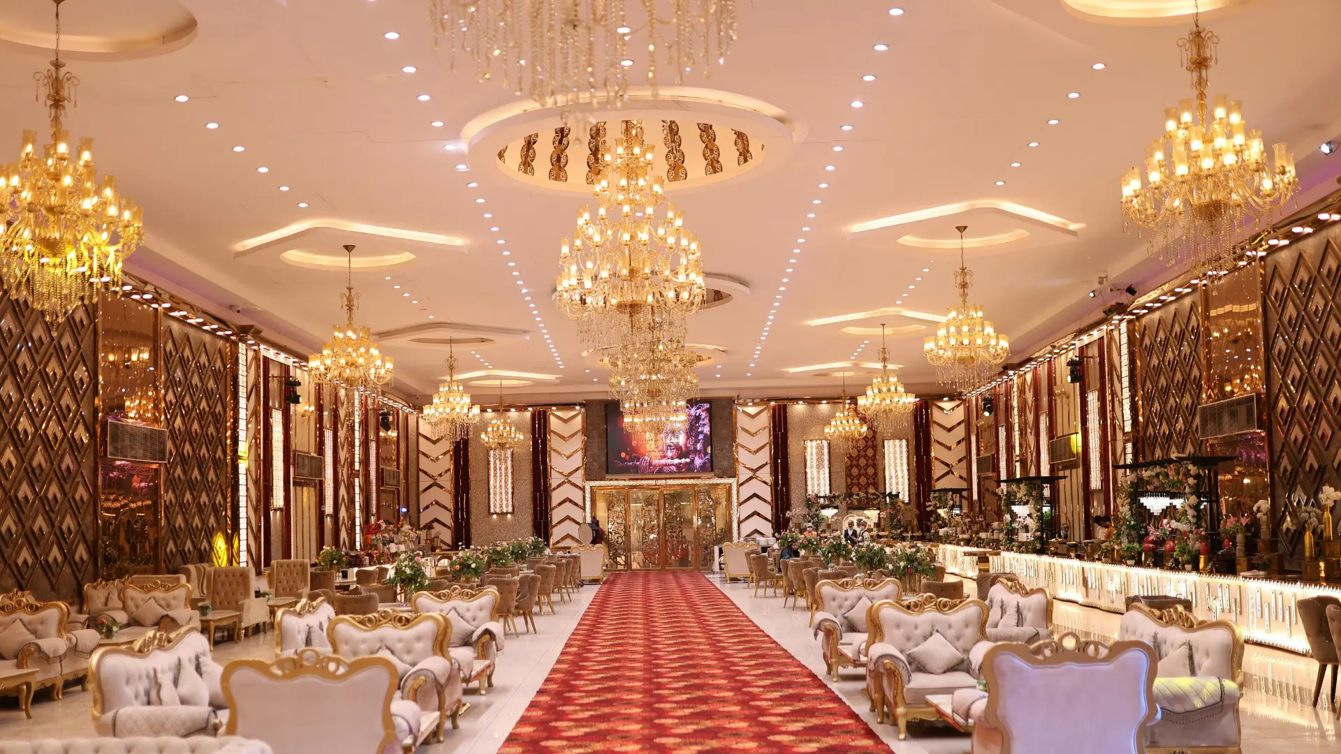 Luxury banquet hall with chandeliers and grand wedding setup